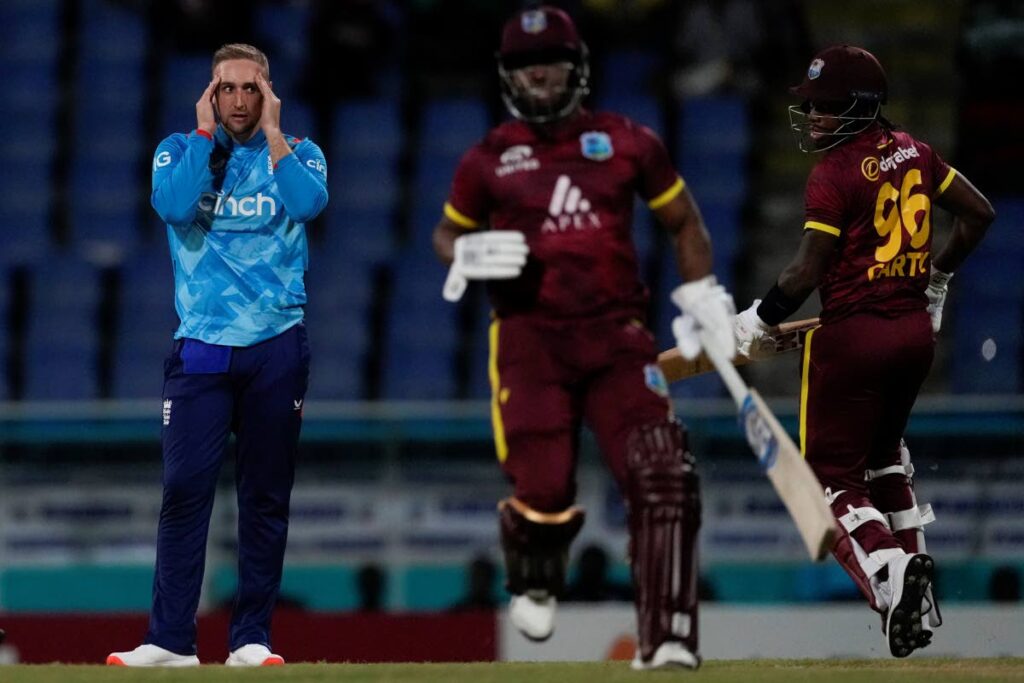 England's captain Liam Livingstone reacts after a delivery as West Indies' Keacy Carty and Evin Lewis run during the first ODI at Sir Vivian Richards Ground in North Sound, Antigua and Barbuda,on October. 31, 2024. (AP Photo) - 