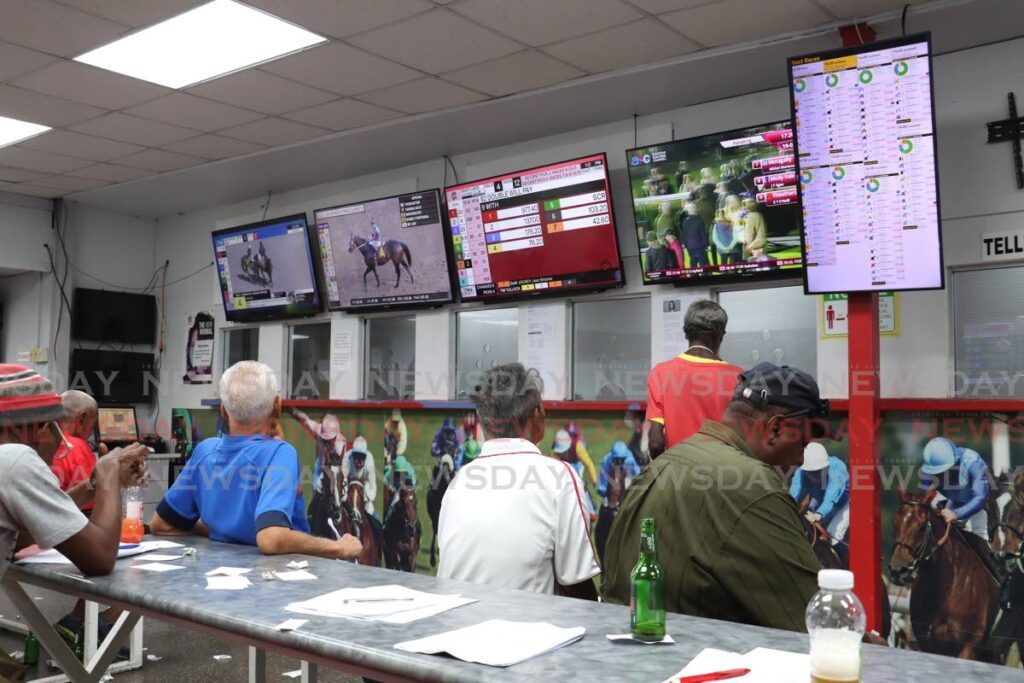 Punters eagerly watch the races at the TriniBet betting agency on Park Street, Port of Spain on November 2,2024. - Photo by Faith Ayoung