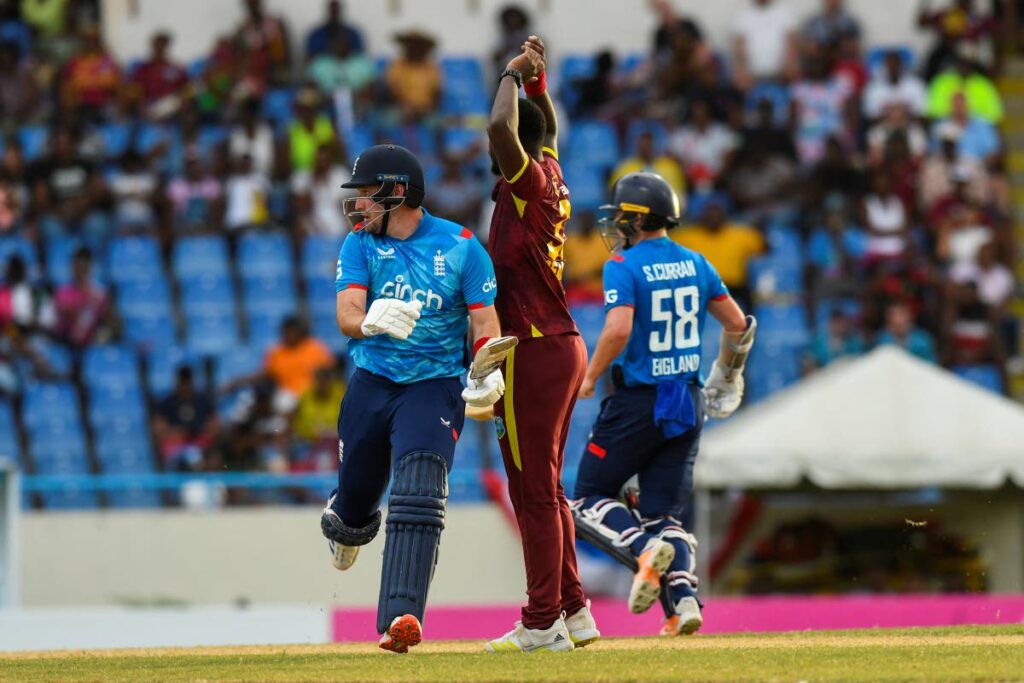 Liam Livingstone (L) of England almost collides with Jayden Seales (C) of West Indies during the 2nd ODI at Sir Vivian Richards Cricket Stadium in North Sound, Antigua and Barbuda, on November 2. England won by five wickets.  - AFP PHOTO