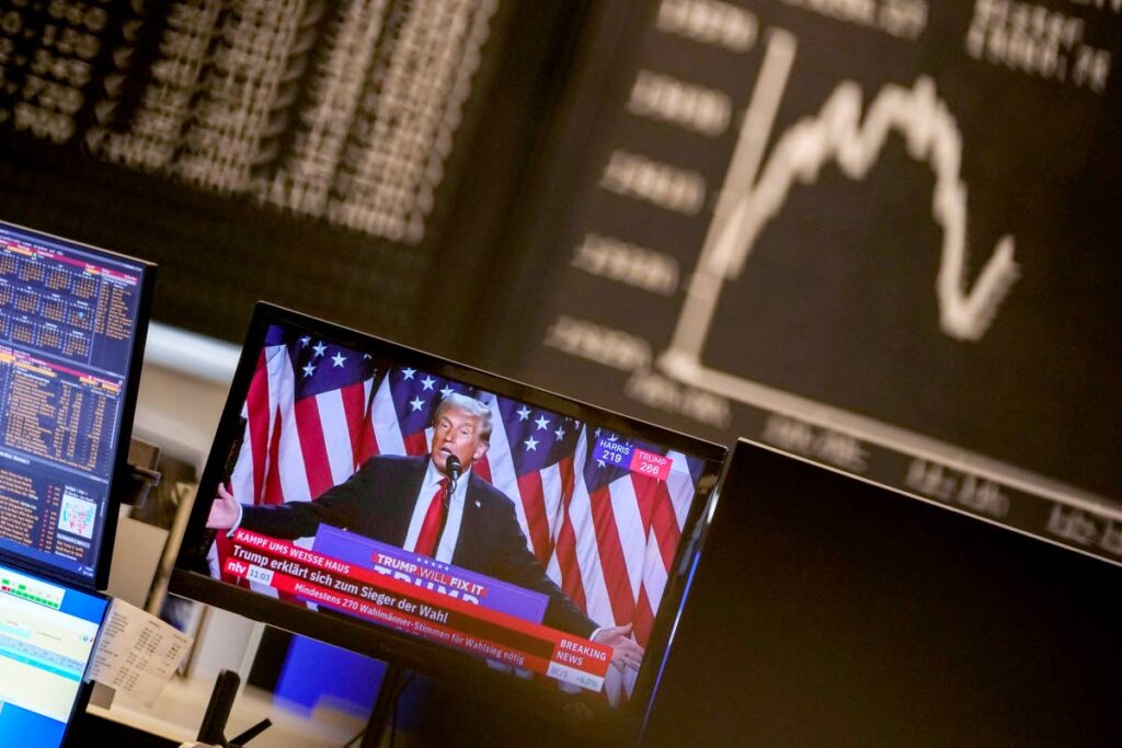 US president-elect Donald Trump appears on a television screen at the stock market in Frankfurt, Germany, on November 6. AP Photo - 