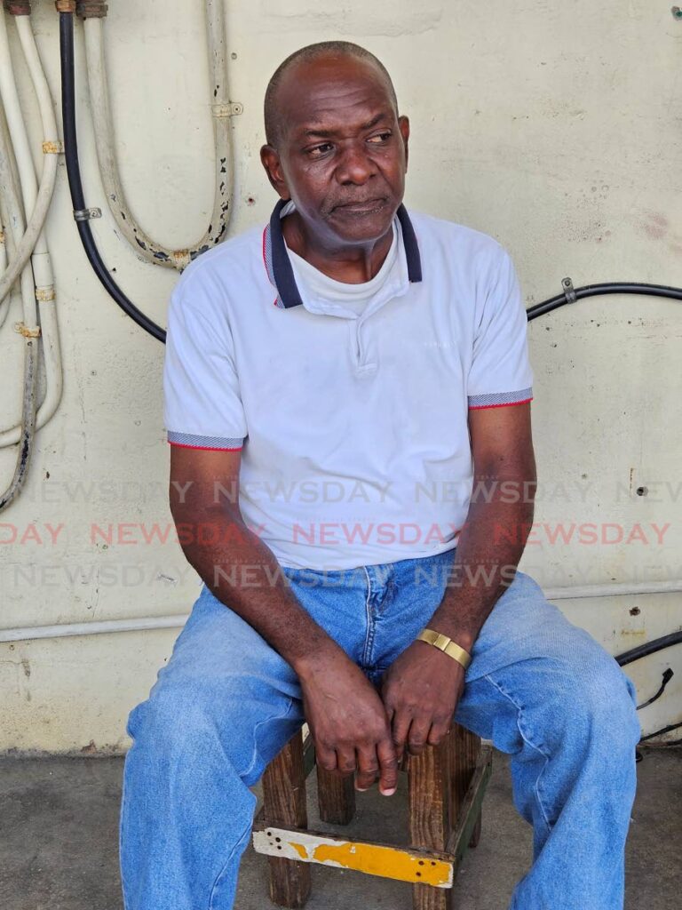 Marlon Charles, 56, had his foot stuck in the hole of a metal drain cover in front of ‘Bago Boyz bar on Carrington Street, Scarborough. - Photo by Janelle De Souza