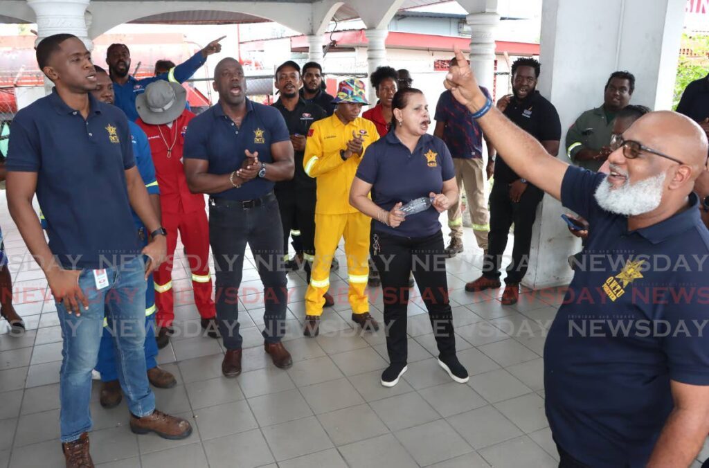 Oilfields Workers' Trade Union chief education and research officer and treasurer Ozzie Warwick, right, chants songs with NP workers during their lunch time protest, at NP, Sea Lots on November 8. - Photo by Angelo Marcelle