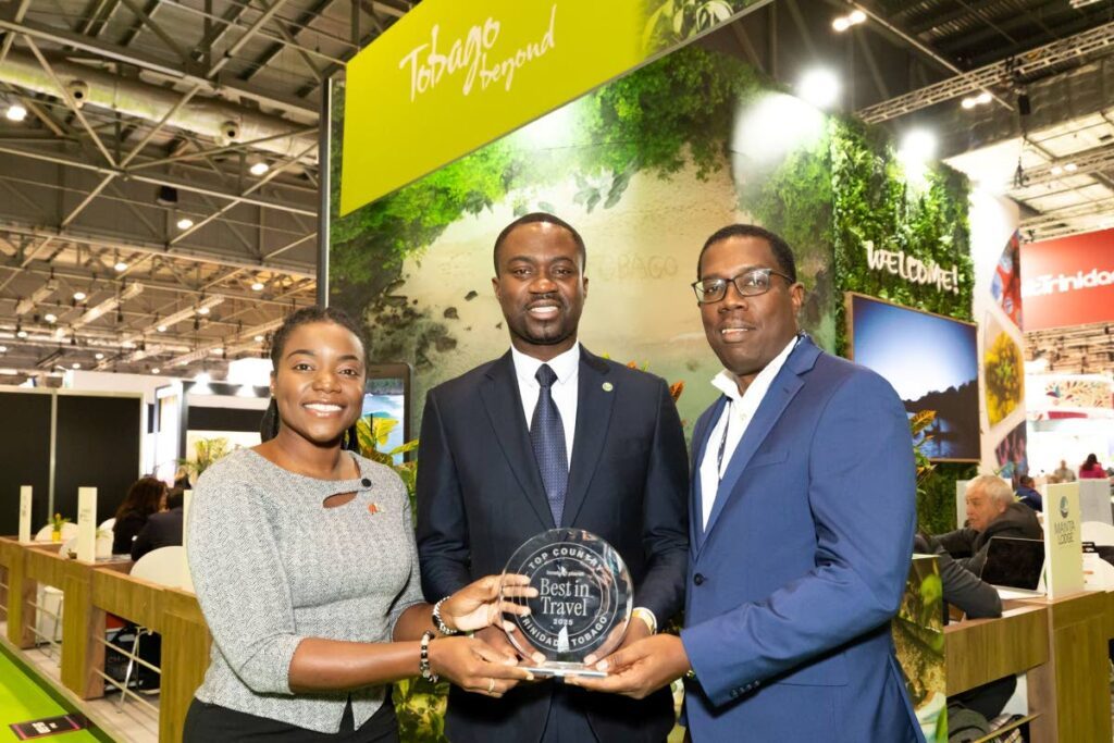 Chief Secretary Farley Augustine, centre, Secretary of Tourism Tashia Burris, left, and Tobago Hotel and Tourism Agency president Alpha Lorde, with the Lonely Planet award, at World Travel Market, London. - 