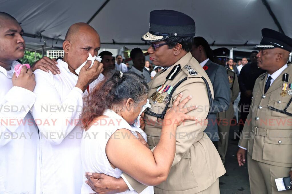 Commissioner of Police Erla Harewood-Christopher, right, offers support to Arrilla Banahar, the mother of PC Krishna Banahar, at the officer's funeral service in Fyzabad on November 9. The officer was shot dead in the line of duty on November 6 in Guapo.  - Photo by Lincoln Holder 