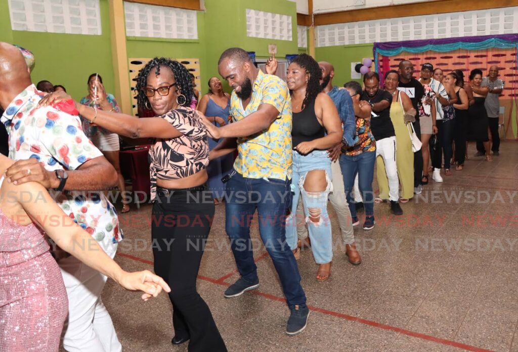 The conga line keeps the party going at the Valencia Secondary's fundraising party at the school on Vega de Oropouche Road. - Photos by Angelo Marcelle