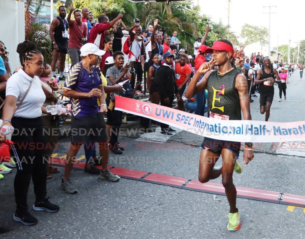 Tafari Waldron finishes first in the UWI SPEC International Half- Marathon at the UWI Sports and Physical Education Centre in St Augustine on November 10. - Photos by Ayanna Kinsale