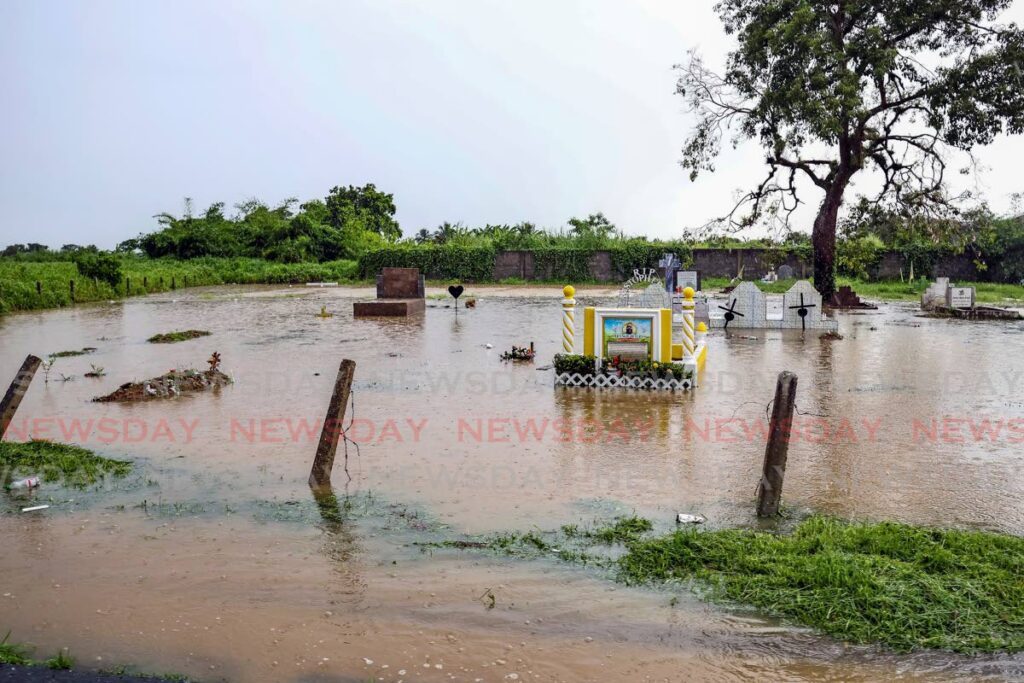 Sharp, heavy showers on November 12 led to widespread flash flooding, leaving many areas in south Trinidad, including the Batchyia cemetery in Penal, under water. - Photo by Lincoln Holder