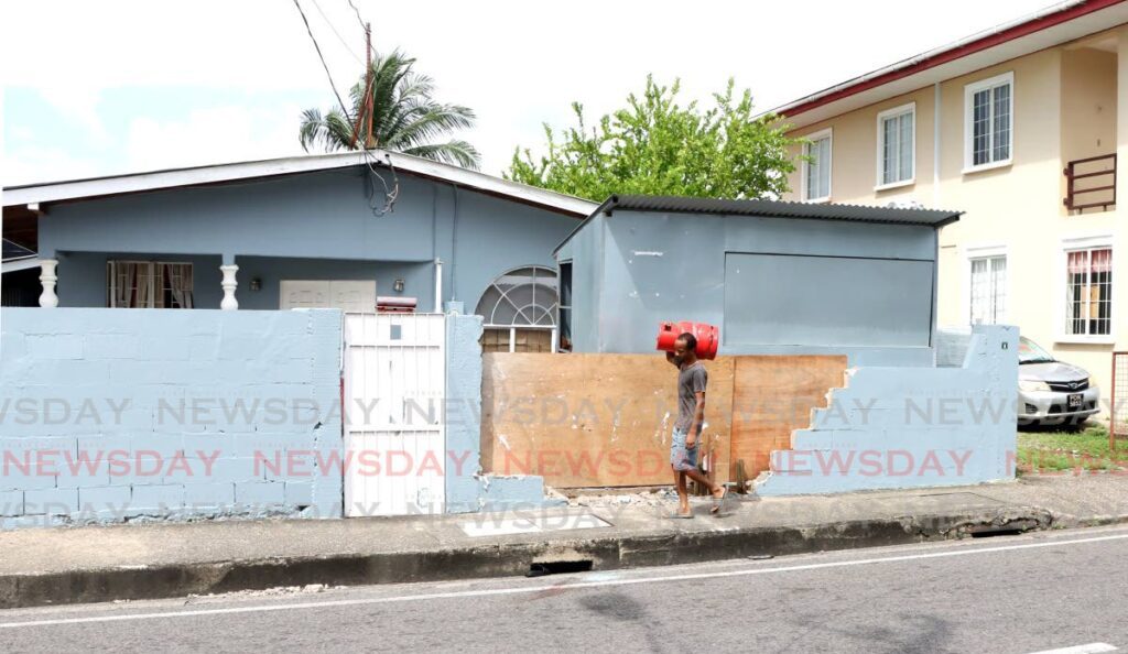 A wall near Mission Based International Ministries on Belmont Circular Road was damaged on November 12 when three men in a white Mazda crashed after being shot.  - Photo by Ayanna Kinsale