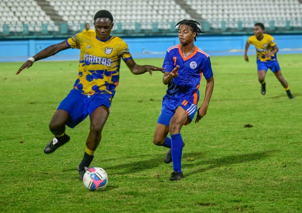 A Speyside High player, left, is marked by a Scarborough Secondary rival in the SSFL Tobago Intercol semis on November 12 at Dwight Yorke Stadium, Bacolet.  - Visual Styles