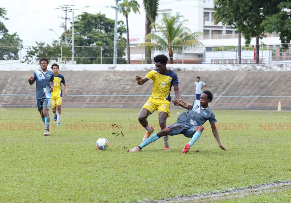 Arima North player Nkosi Fuentes, right, tackles Trinity College East footballer Anderson Barnwell during the East zone Intercol semifinal at Arima Velodrome on November 13.  - Faith Ayoung