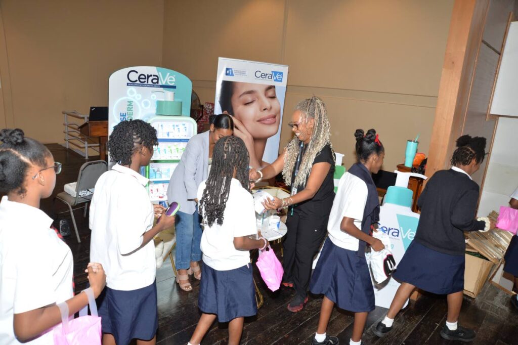 Representatives of CeraVe distribute products to schoolchildren in Bishop’s Anstey High School in Port of Spain. - - Photo courtesy  Lonsdale Saatchi & Saatchi Advertising Ltd