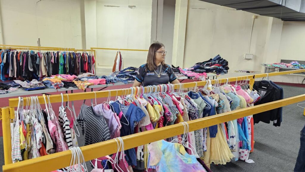 A Sewa volunteer sorts clothes for charitable donation at the Divali Nagar last week. - 