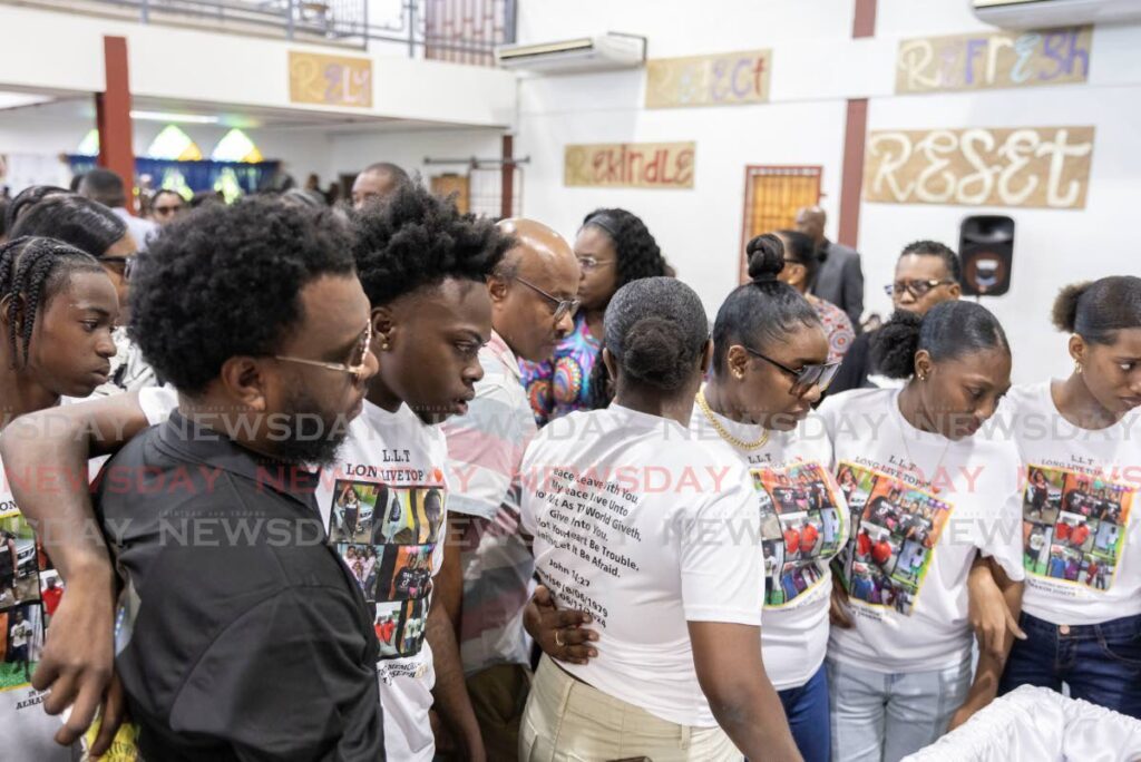 Relatives of Alhakim Joseph view his body during his funeral at the Lot Ten Village Open Bible Church, Guapo on November 16. - Photo by Jeff K. Mayers