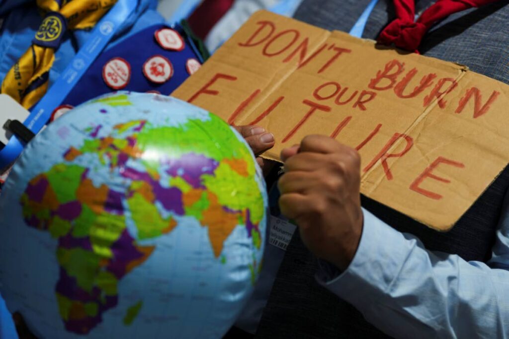 Demonstrators hold a sign 