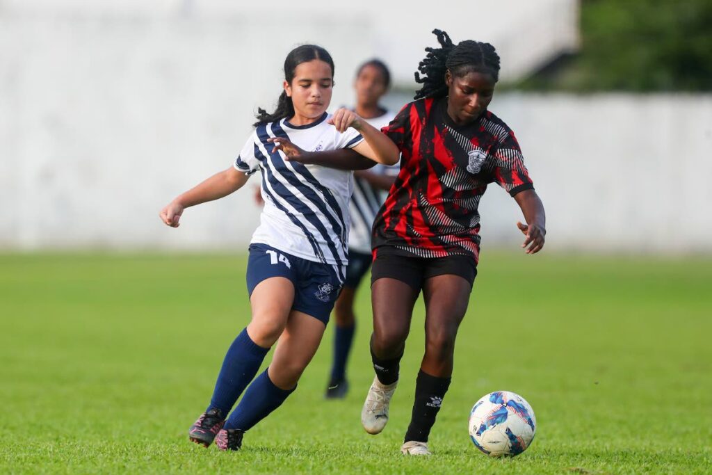 St Joseph Convent Port of Spain's Anushka Persad (L) tries to get the better of Bishop Anstey High's D’nae Bradshaw during the SSFL Coca-Cola Intercol Girls' North Zone semifinal at the St Mary’s College ground on November 19, 2024 in Port of Spain. - Daniel Prentice