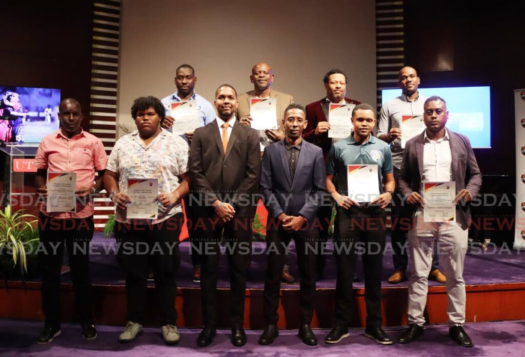 Several club officials display their new TT Premier Football League licences during the league's launch on November 19, at the National Academy for the Performing Arts (NAPA), Port of Spain. - Photo by Ayanna Kinsale