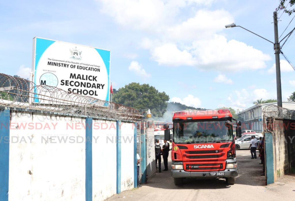 A fire tender leaves Malick Secondary School after a fire at the school was brought under control on November 20. - Photo by Ayanna Kinsale