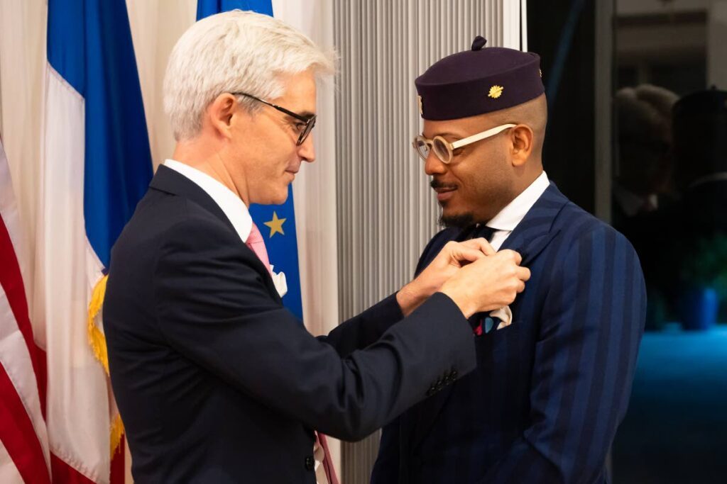 Etienne Charles receives his award from Raphael Trapp, Consul General of France in Miami, Florida on November 20.  - Photo courtesy Maria Nunes