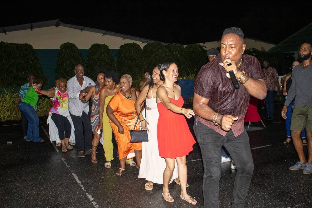  Eddie Charles leads the conga  line at Sweat Equity Crew's Pork & Parang 2 event. - 