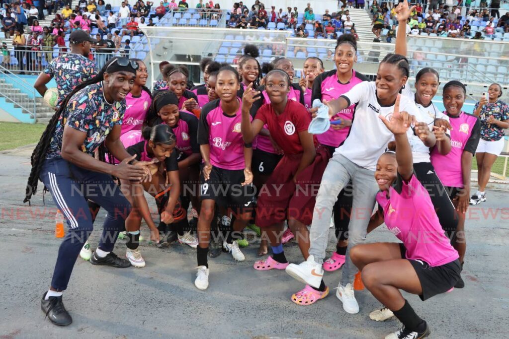 Pleasantville Secondary School coach Brian London celebrates with his team after winning against Moruga Secondary School during the South Zone Girls' Intercol at the Ato Boldon Stadium in Couva. - Photo by Ayanna Kinsale