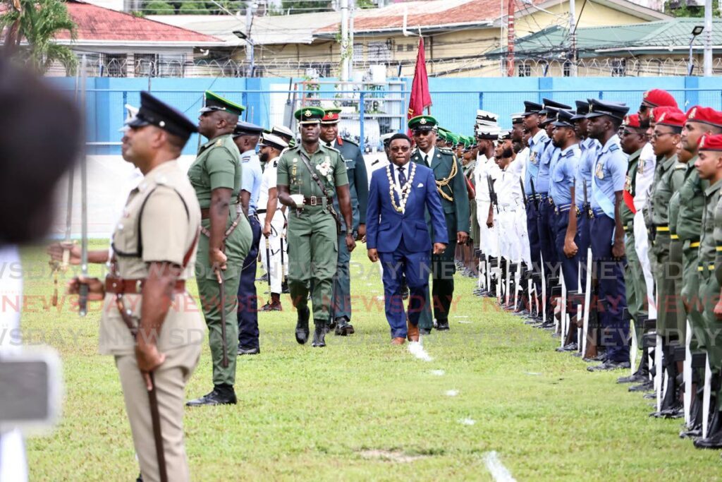 San Fernando mayor Robert Parris inspects the detachments at Skinner Park, San Fernando on Saturday before the miliary parade to commemorate the 36th anniversay of the sourthern city. - Photo by L:incoln Holder 