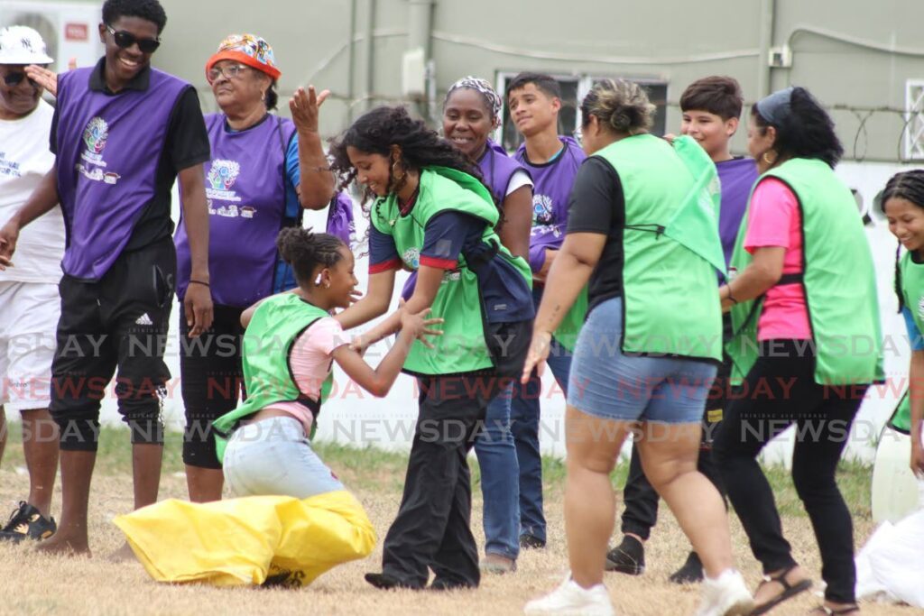 Venezuelan immigrants and locals play traditional games during a day of social inclusion and brotherhood organised by the International Organization for Migration  in Longdenville, Chaguanas on April 1. - Photo by Grevic Alvarado
