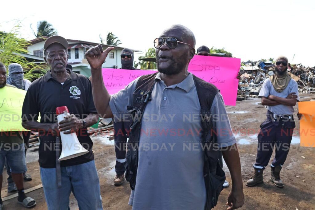 President of the Scrap Iron Dealers Association Allan Ferguson and other members accused foreigners of owning and running the yard, claiming they are trying to take over the industry from local dealers. - Photo by Lincoln Holder 