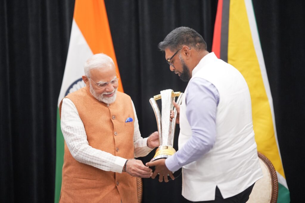 Indian prime minister Narendra Modi (L) is shown the Global Super League T20 trophy by Guyana president Dr Irfaan Ali at a cricket event which was part of the Indian leader's state visit to Guyana last week. Photo courtesy Global Super League. 