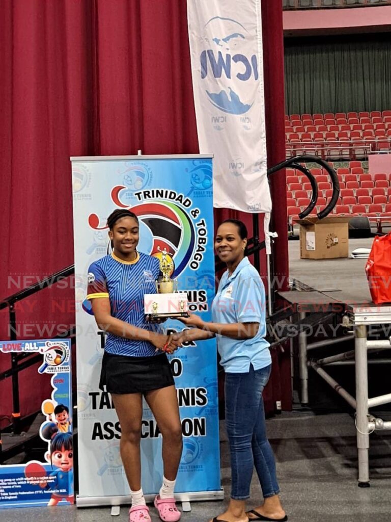 QPCC’s Imani Edwards-Taylor receives one of her two trophies after winning the women’s and girls’ U19 singles events at the Tobago Table Tennis Open.  - (via Tobago Table Tennis Open)