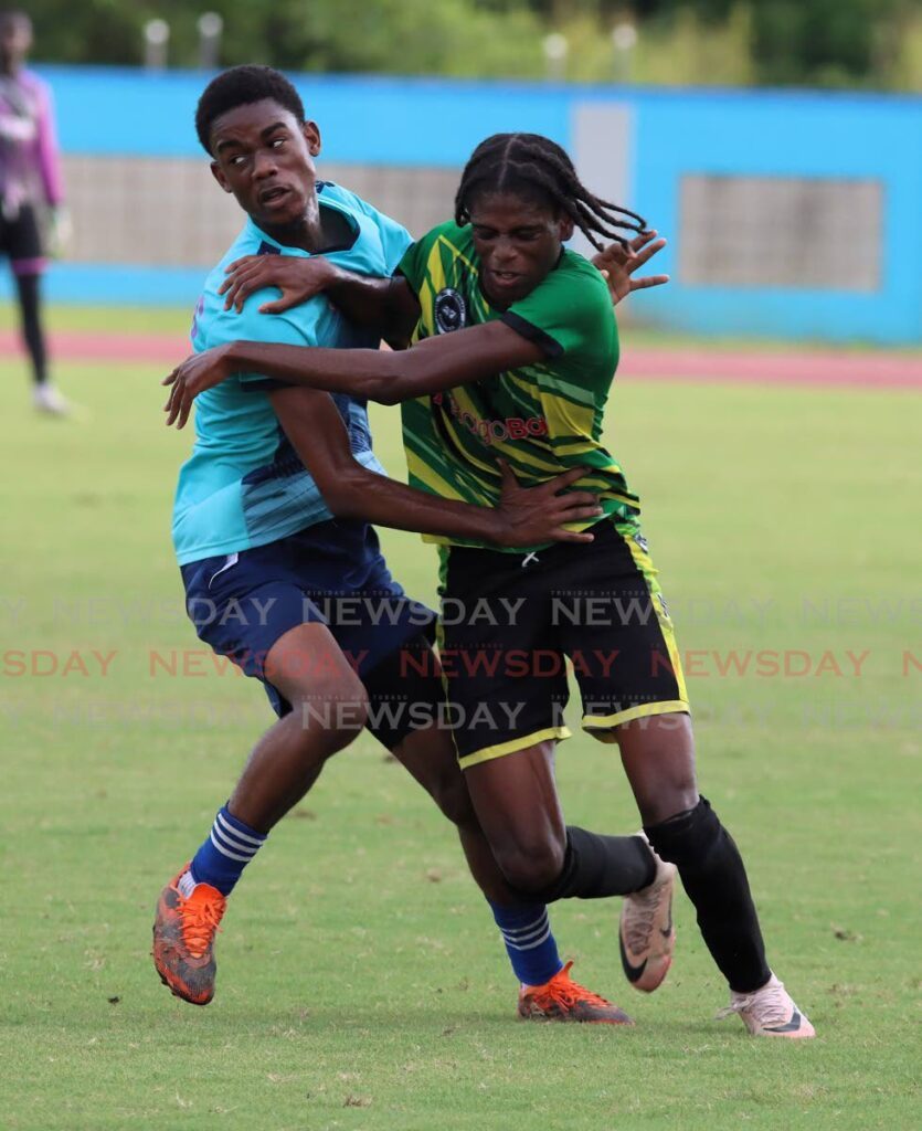 Signal Hill Secondary’s Israel Trim (R) and Miracle Ministries’ Immanuel Marchan in action during the Coca-Cola national intercol quarterfinal, om November 26, at the Ato Boldon Stadium, Couva.  - Photo by Angelo Marcelle