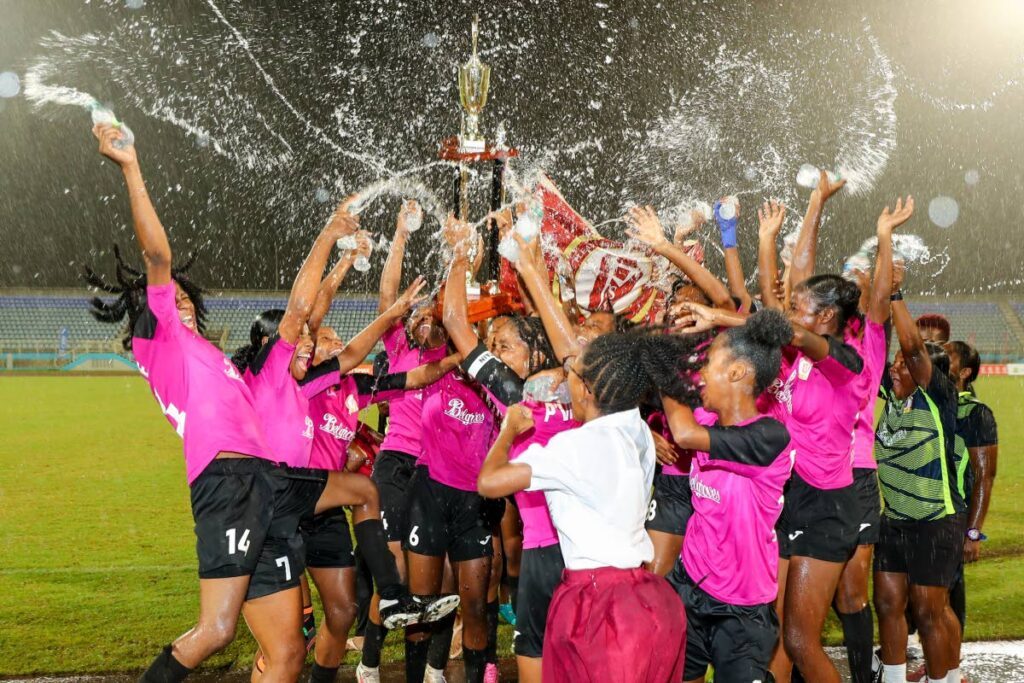 BIG CHAMPS: A joyous Pleasantville Secondary girls football team celebrates after beating Five Rivers Secondary 3-0 in the Secondary Schools Girls' Big Five final, on November 26, at the Ato Boldon Stadium, Balmain, Couva.  - Photo courtesy Daniel Prentice