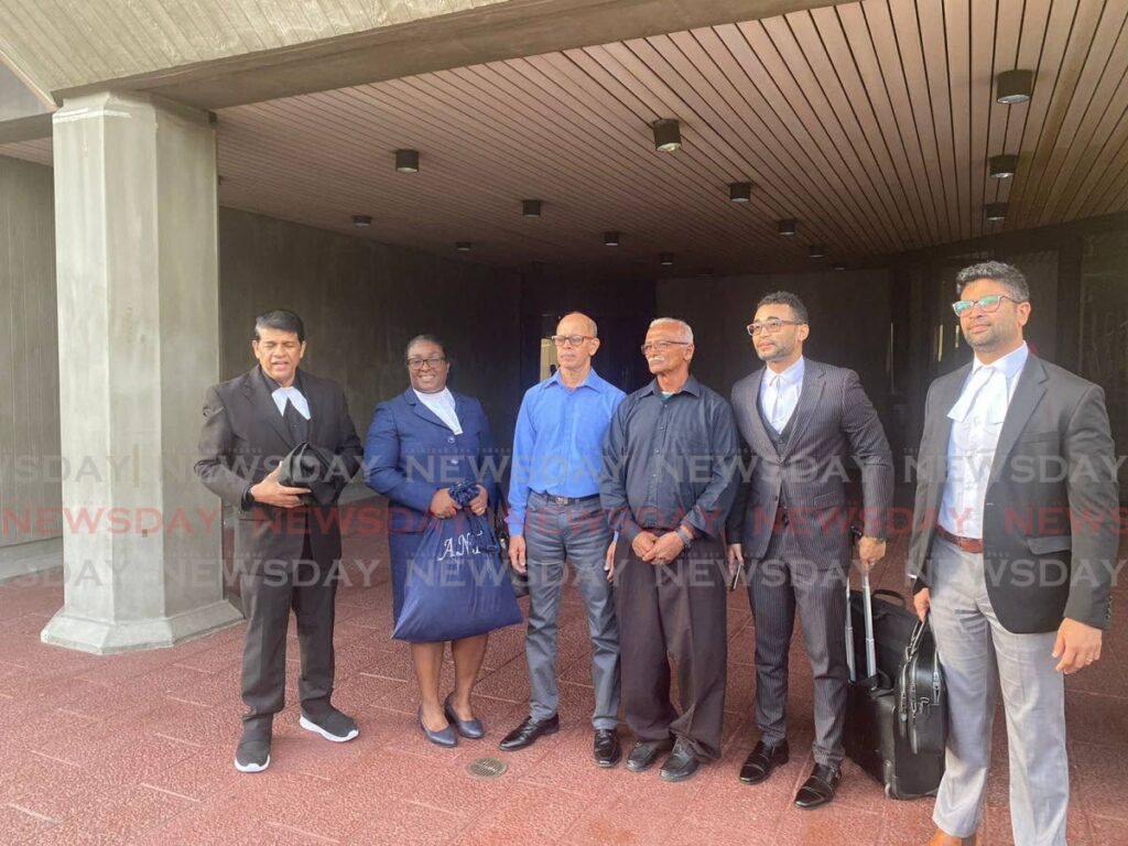 Ricky Samlal and  Shaffeth Mohammed, third and fourth from left, with their attorneys Prakash Ramadhar,  Adaphia Trancoso-Ribeiro,Collin Elbourne and Ved Trebouhansingh at the Hall of Justice, Port of Spain, on November 26. - 