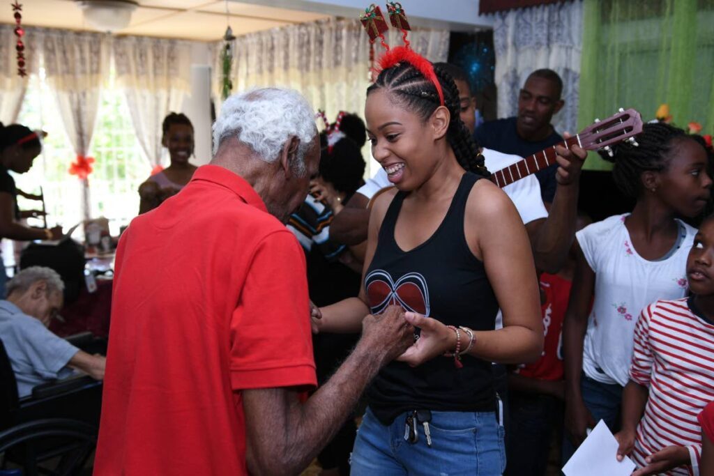 Sasha Bernard dances with a resident of a senior home. - 