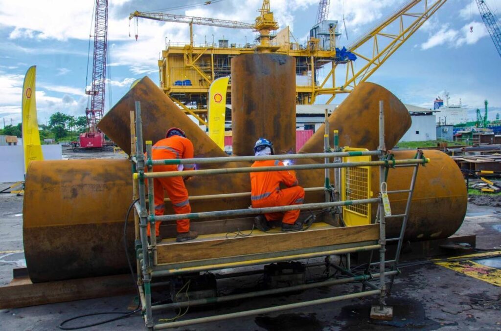 Workers cut steel to signal the commencement of the local fabrication phase for the Manatee project. - Photo courtesy Ministry of Energy