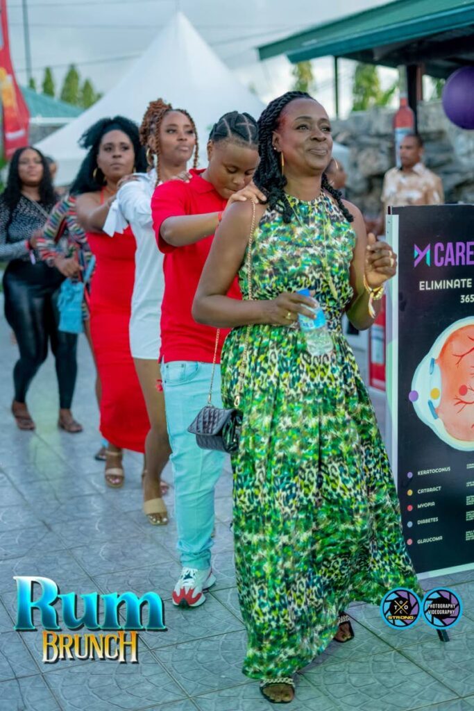 Patrons form a conga line at Rum Brunch 2023. - 