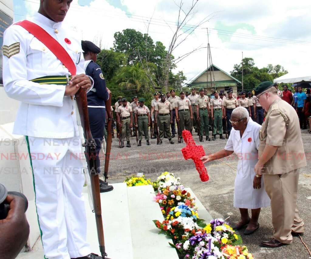 2nd Lt of the Trinidad and Tobago Defence Force Billy Chrism, right, assists war veteran Mary Anthony during a wreath laying ceremony during the TT Legion of Commonwealth Ex-services League, Southern Branch, at the Remembrance Day memorial service at the Fyzabad Cenotaph, November 11, 2018. FILE PHOTO -