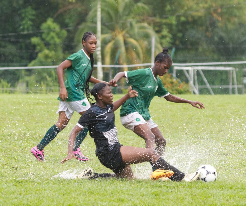 San Juan North Secondary's Shinika Lewis, right, tries to ride a tackle from a St Augustine Secondary player during Coca-Cola girls' East zone intercol semifinal action at San Juan North Secondary on November 18. - Photo courtesy Brian Miller