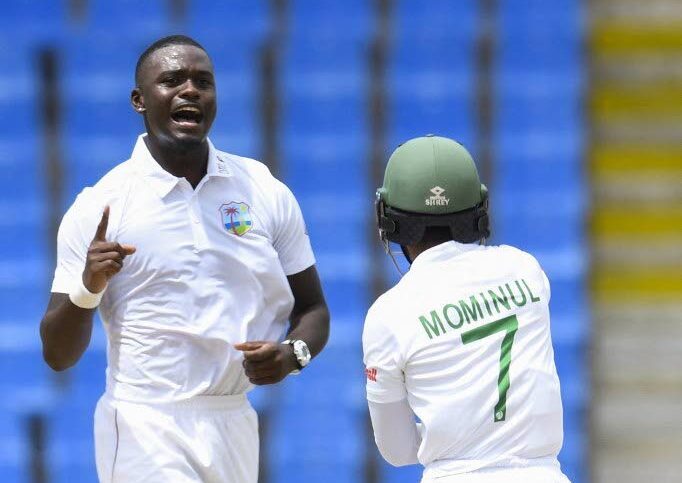 West Indies’ Jayden Seales, left, celebrates the dismissal of Mominul Haque, right, of Bangladesh during the first day of the first Test at the Sir Vivian Richards Cricket Stadium in North Sound, Antigua, on June 16, 2022. - AFP PHOTO