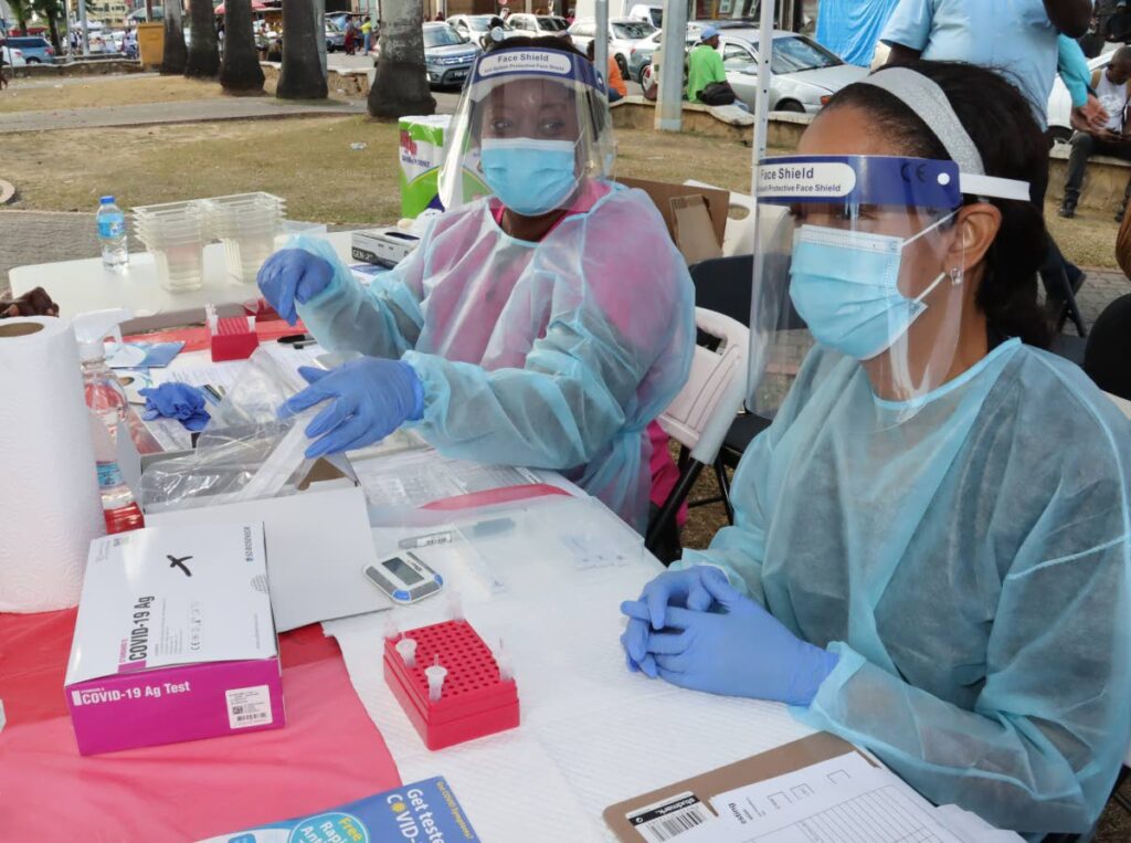 In this file photo, medical lab technicians sreen people who volunteered to be tested for covid19 on the Brian Lara Promenade, in Port of Spain in February 2023. - 