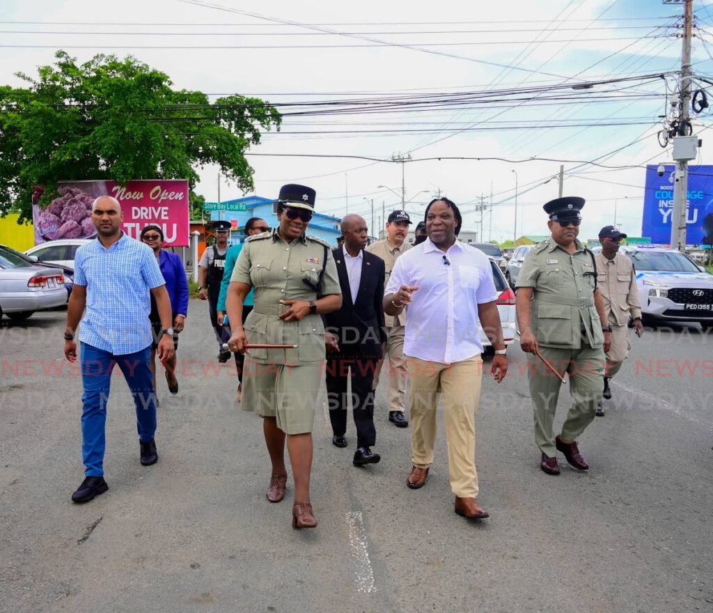 Keith Scotland, minister in the ministry of national security, and CoP Erla Harewood-Christopher lead a walkabout in Crown Point, Tobago on August 12. - Photo courtesy Visual Styles