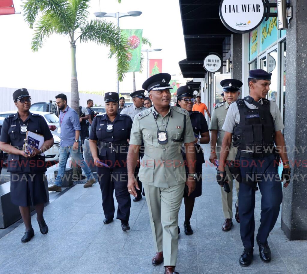 ACP Wayne Mystar, centre, during the launch of the police confidence patrols at South Park in San Fernando in November. Recent initiatives including greater police visibility have borne fruit with a reduction in murders over the past three months. - Ayanna Kinsale