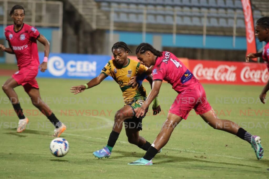 In this file photo, St Benedict's College striker Derrel Garcia (C) and Naparima's Antonio Hills go after the ball during the Coca-Cola South zone Boys Intercol final at the Ato Boldon Stadium in Couva on November 22.  - Photo by Ayanna Kinsale 