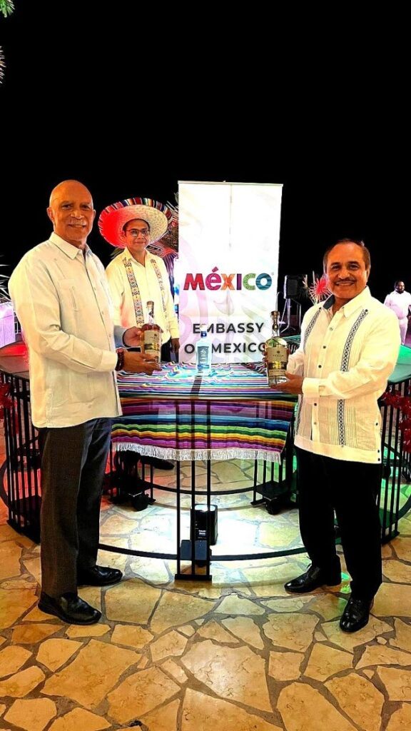 From left, Michael Hooper, general manager of Hyatt Regency Trinidad with the Mexican ambassador Victor Hugo Morales, right, show bottles of premium tequila during the Mexican Latin Night on November 21 at the Hyatt Regency Trinidad.
 - Photo courtesy the Mexican Embassy