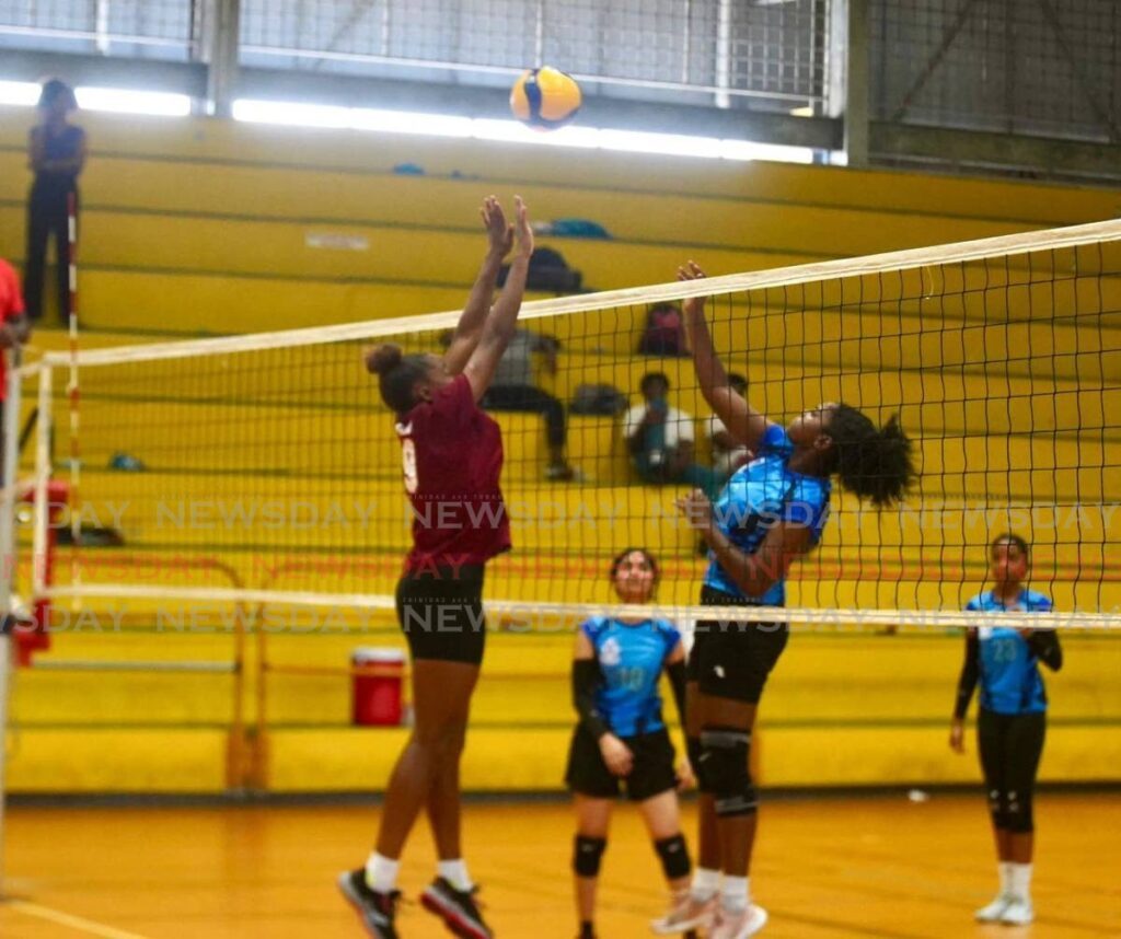 In this file photo, Pleasantville Secondary's volleyball player Nikita Gosine (left) challenges her opponent at the net. 