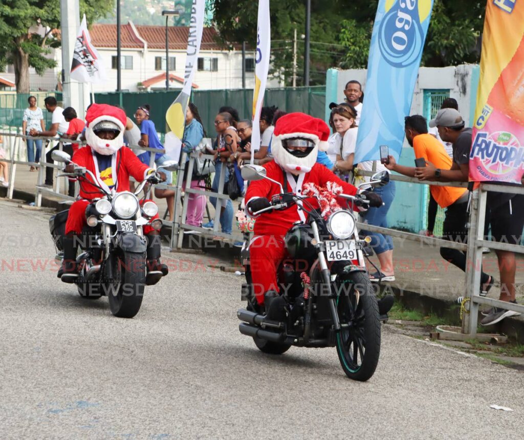 These bikers dressed as Santa Claus ride through the Shine 5K and 10K Charity Walk and Run at the Nelson Mandela Park, St Clair, Port of Spain, November 30. - Photos by Ayanna Kinsale