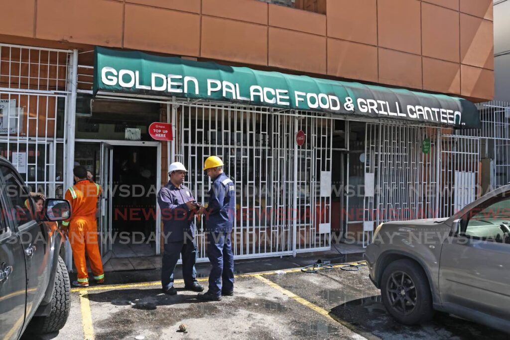 Fire officers conducting their investigations after a fire broke out at Golden Palace Restaurant and Food Grill Canteen, Southern Main Road in Marabella on December 2. - Photo by Lincoln Holder