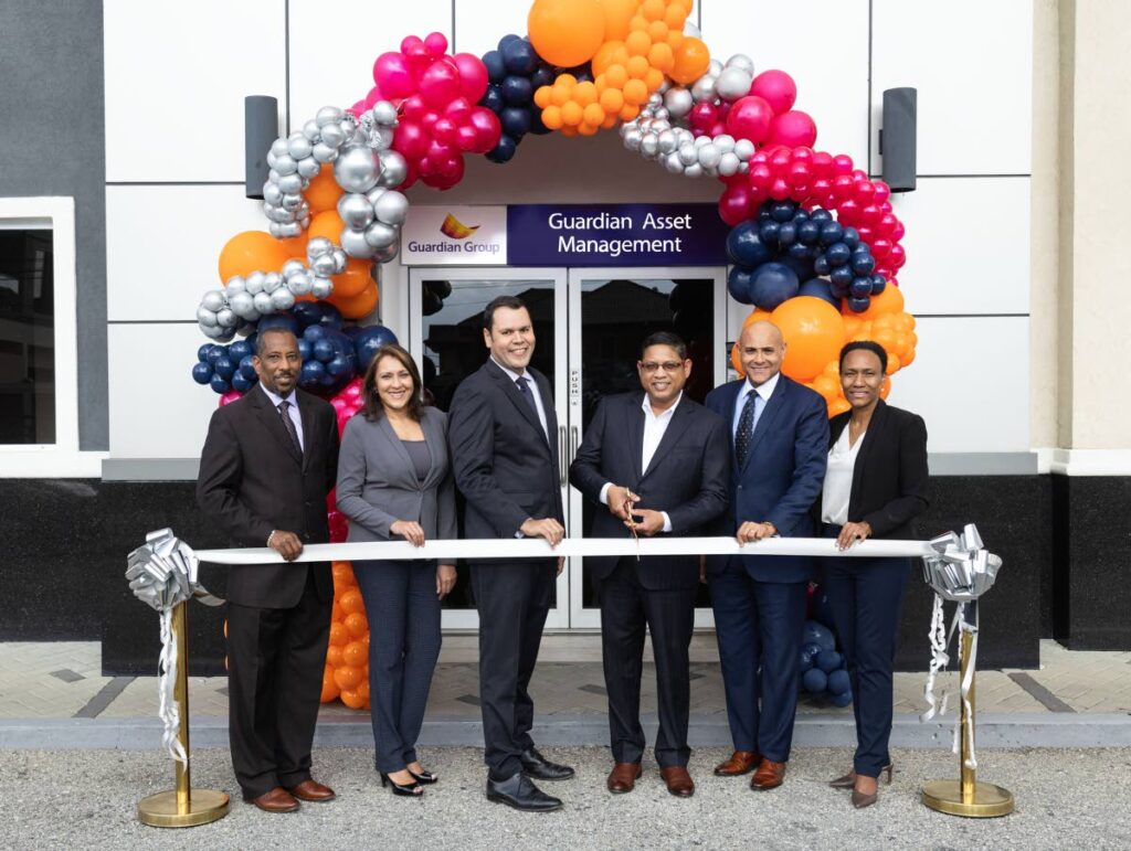 NEW BRANCH OPENING: Paul Wynter, VP of Strategic Initiatives and Special Projects, left; Narisa Hosein, VP of Investments; Miguel Martinez, GAM president; Ian Chinapoo, Guardian Group CEO and chairman; Emile Clifton, VP of Sales and Marketing, and Thandi Merritt, VP of Operations and Technology, cut the ribbon at the opening of GAM's new branch in Brentwood, Chaguanas. - Photo courtesy GAM 