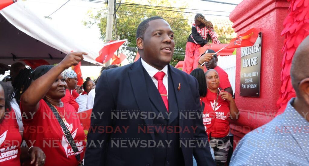 RED AND READY: Attorney Kareem Marcelle arrives with supporters at Balisier House in Port of Spain on December 2 to be screened as a potential candidate for the Laventille West seat for the general election. - Photo by Faith Ayoung