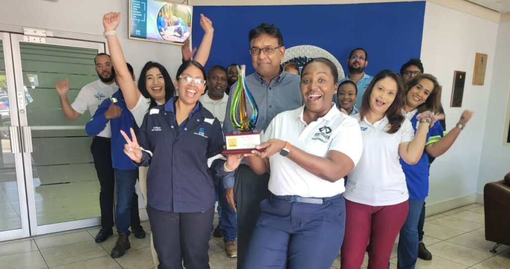 Ansa Packaging head of operations Cyril Coomansingh and sustainability officer Jiselle Granderson, centre, with members of the packaging team celebrate the TTMA Green Manufacturer award. - Photo courtesy Ansa Packaging