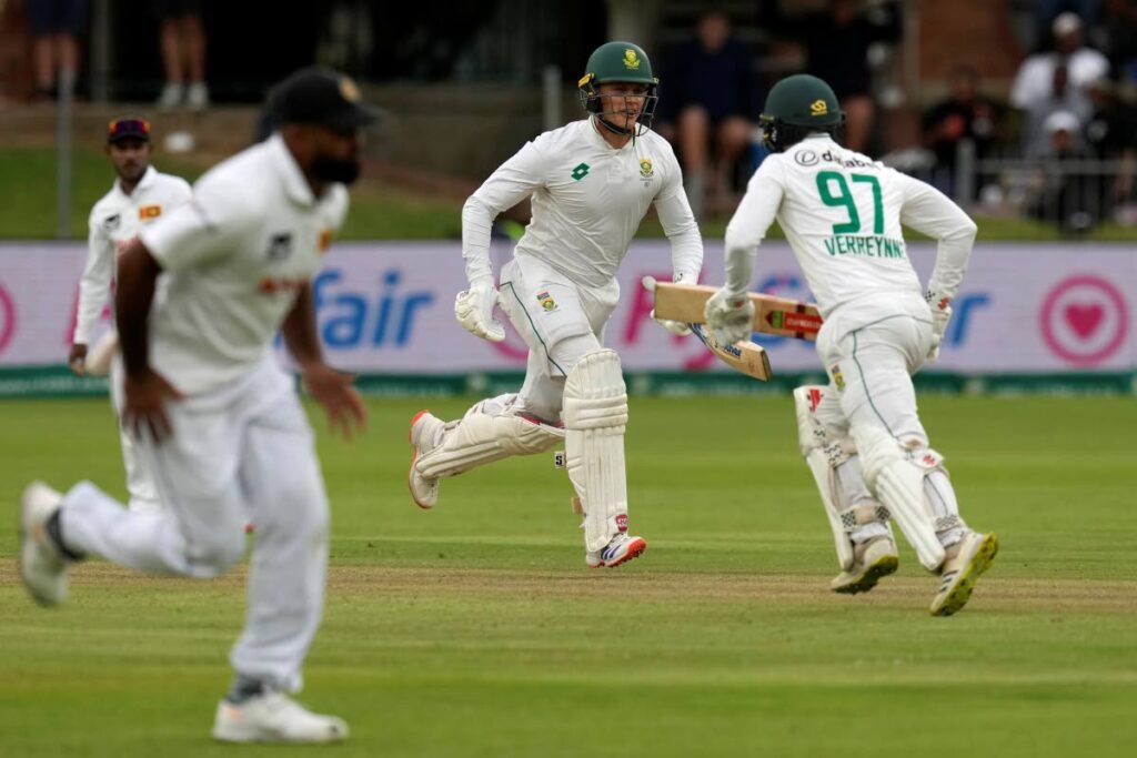 South Africa's Ryan Rickelton, centre, runs as he reaches his maiden Test match century during the first day of the second Test cricket match between South Africa and Sri Lanka, at St George's Park in Gqeberha, South Africa, Thursday, Dec. 5, 2024. (AP Photo/Themba Hadebe) - Themba Hadebe